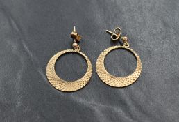 A pair of 9ct gold stud earrings having bright cut circular drops, approx 3.1g