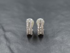 A pair of white gold hoop and post diamond earrings stamped 750 having central row of baguette cut