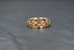 A 9ct gold eternity ring having ruby and cubic zirconia stones in an open setting, one ruby missing,