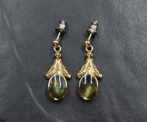A pair of 9ct gold labradorite earrings having collared mounts with moulded drops to stud poles,