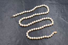 A single row of cultured pearls, having a white to cream lustre with a 14ct hook clasp,