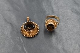 A high carat gold smoky quartz ring and pendant set, the oval cut smoky quartz in a bezel setting