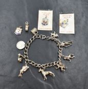 A silver charm bracelet, having nine white metal charms including a rabbit, a Norman soldier and a
