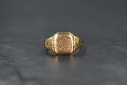 A gent's 9ct gold signet ring having worn engraving to cartouche and engraved inscription en