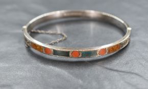 A Scottish silver hinged bangle having mixed agate panelled decoration to one half, Birmingham