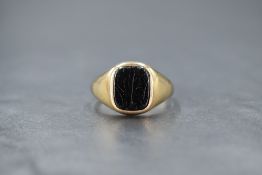 A gent's 9ct gold signet ring having an onyx panel, size W/X & approx 5.6g