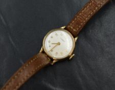 A lady's 9ct gold wrist watch by Tissot having Arabic numeral dial to champagne face in a plain gold
