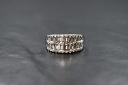 An 18ct white gold diamond five row shaped band ring having two rows of baguette cut diamonds