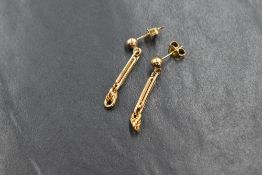A pair of 9ct gold earrings having a gold stud with a bar and chain drop, approx 2.2g