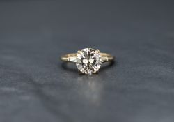A 14ct gold diamond solitaire ring, the central round brilliant cut diamond measuring