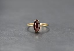 A 9ct gold garnet ring, the marquise cut garnet in a four claw setting, ring size L, 1.6g