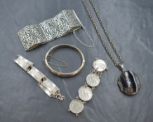A small selection of silver jewellery, comprising a hinged bangle and three bracelets, along with