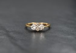 A 1940's 18ct gold four stone diamond cluster ring of symmetrical form, approx 0.5ct total in a claw