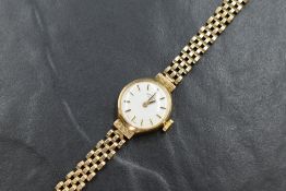 A lady's 9ct gold Rotary wrist watch having a baton dial to champagne face in plain gold case on a