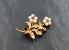A 9ct gold floral brooch having seed pearl and garnet decoration, approx 4.8g
