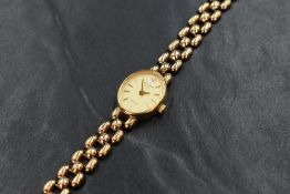 A 9ct gold Accurist wristwatch, the oval champagne dial having baton numerals, on a 9ct gold