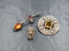 A silver citrine Celtic shield brooch, the central round cut citrine with a silver surround having