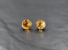 A pair of 9ct gold stud earrings having citrine solitaire stones in claw set mounts, approx 1.5g