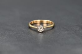 An 18ct gold diamond solitaire ring, the cushion cut diamond measuring approximately 0.33ct in a six