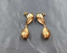 A pair of 9ct gold drop earrings, the gold pear shaped drops having concave decoration, 2.6g