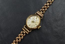A 9ct gold Accurist wristwatch, the marquise champagne dial having baton numerals, on a 9ct gold