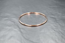 A 9ct rose gold slave bangle of plain form, inner diameter approx 65mm & approx 8.7g