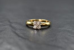 An 18ct gold four stone diamond square set ring having a central diamond chip, total approx 0.5ct,