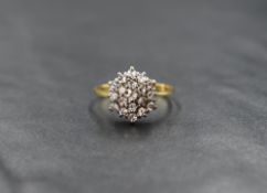 An 18ct gold diamond chip triple cluster ring in a claw set basket mount, ring size N/M and
