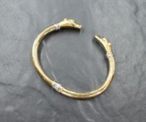 A white and yellow metal panther head hinged bangle stamped 585 having moulded panther head