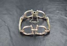 A silver horse bit motif bracelet, the two horse bits joined by bars, with safety chain, 32.3g