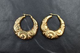 A pair of 9ct gold hoop earrings of moulded form, approx 5.4g