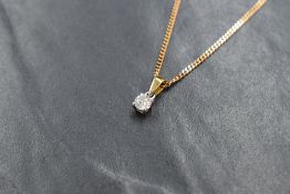 An 18ct gold diamond solitaire pendant, the round brilliant cut diamond measuring approximately 0.