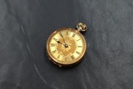 A small yellow metal open face key wound pocket watch marked 14c, the gold tone dial with Roman