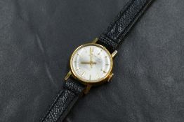 A lady's gold plated Montine wrist watch having baton numeral dial to champagne face in circular