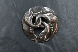 A vintage 1950's silver brooch by Georg Jensen of open circular form with moulded interlinked floral