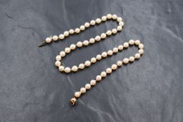 A string of cultured pearls of slightly uneven form having a 9ct gold clasp, approx 16'