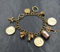A 9ct gold curb link bracelet, having three sovereigns in removable mounts and a further eight