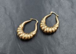 A pair of 9ct gold hoop earrings of moulded oval form, approx 3.7g