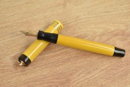 A Parker Duofold vest pocket button fill fountain pen in Mandarin Yellow with three gold bands to