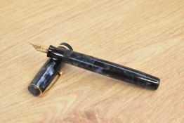 A Parker Premiere button fill fountain pen in blue and black marble with single gold cap band having