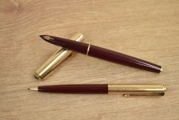A Parker 61 converter fill fountain pen and propelling pencil in maroon with rolled gold cap