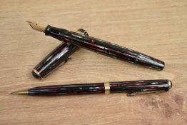 A Parker Duofold Senior button fill fountain pen and Propelling pencil in red and black striated