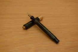 A Parker Duofold Lady Lucky Curve button fill fountain pen in jade green with a broad gold band to