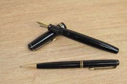 A Parker Duofold Victory button fill fountain pen and propelling pencil in black with two gold cap