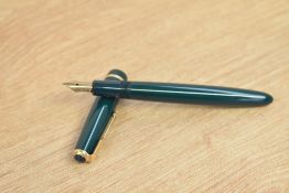 A Parker Duofold Junior aerometric fill fountain pen in green with single gold chevron cap band