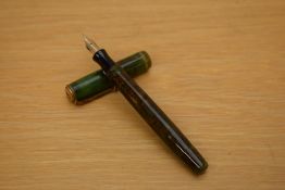 A Parker Moderne button fill fountain pen in green and gold marble with single gold cap band having