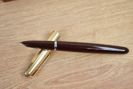 A boxed Parker 51 MKII aerometric fill fountain pen in dark maroon with rolled gold cap