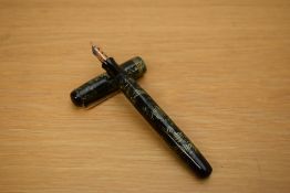 A Parker Televisor Standard button fill fountain pen in lined green with three gold cap bands having