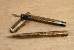 A boxed Parker Vacumatic fountain pen and propelling pencil in Golden web pattern with two narrow