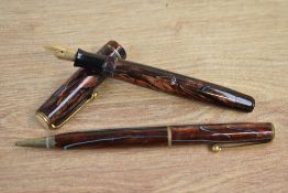 A boxed Parker Moderne button fill fountain pen and Propelling pencil in burgundy marble with blue